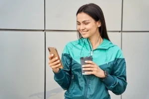 woman holding mobile phone and smiling
