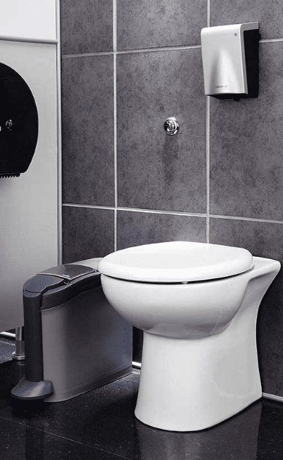 Menstrual hygiene disposal unit beside a toilet