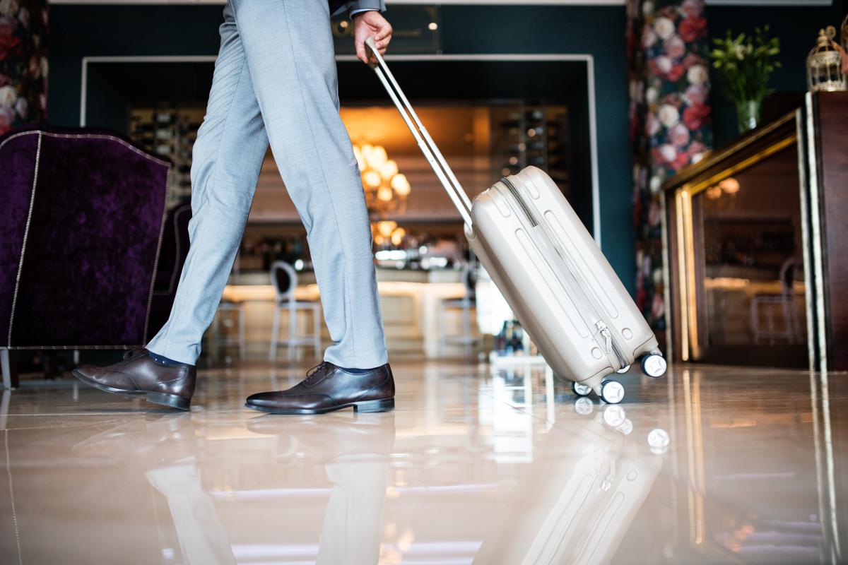 Businessman entering hotel with luggage