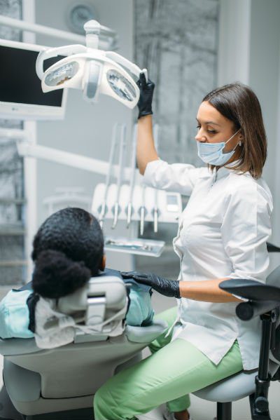 dentist attending patient with gloves and facemask