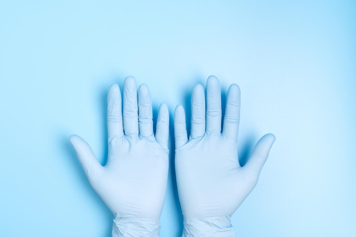 two hands in medical latex gloves