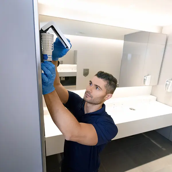 Citron Hygiene washroom services provider male servicing air care system