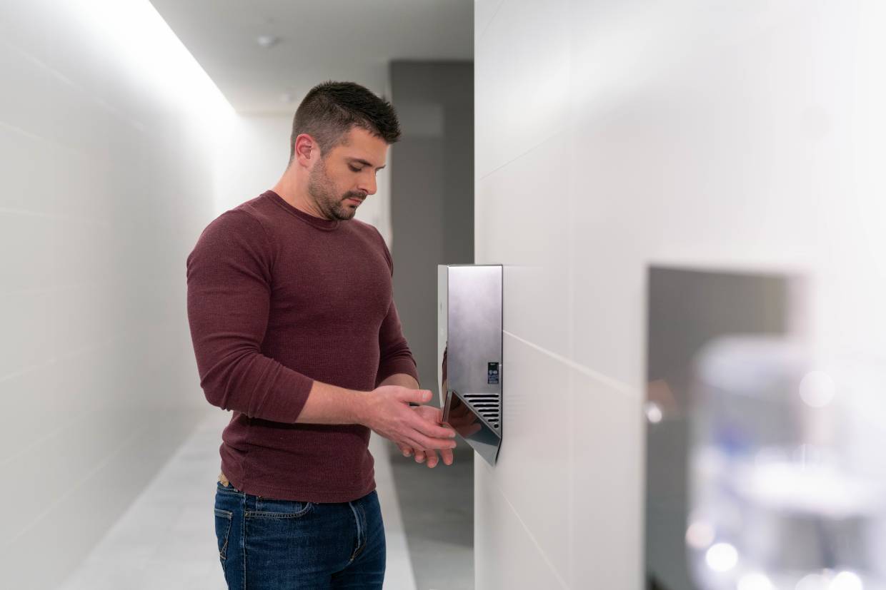 Citron Hygiene man using hand dryer in public washroom